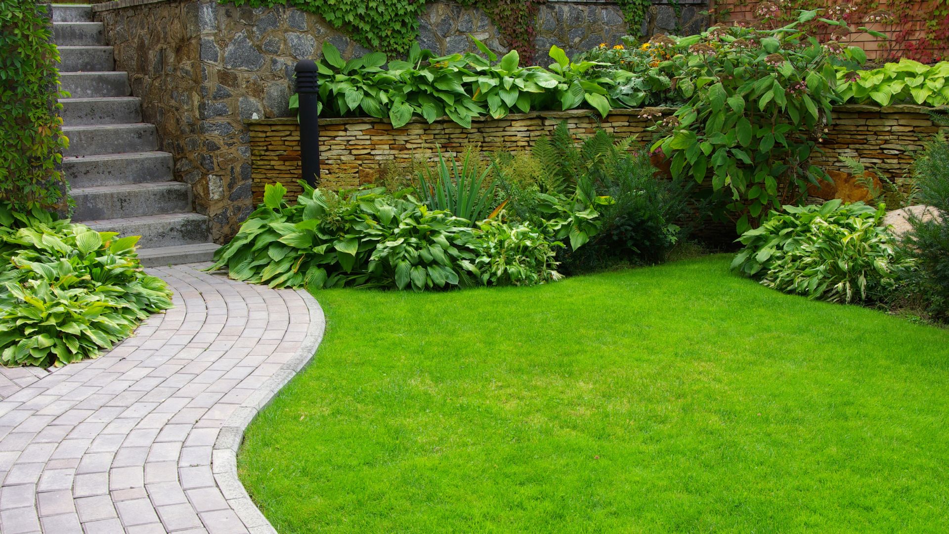 Landscaping team laying fresh sod in a garden